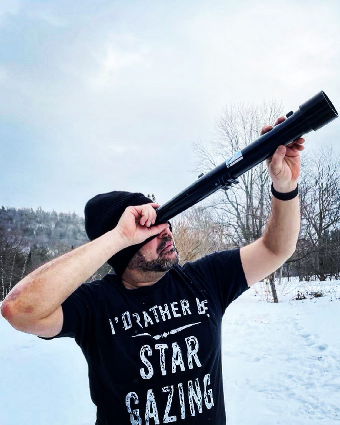 Bobby Farlice-Rubio a Science and History Educator and Storyteller looks up through a telescope